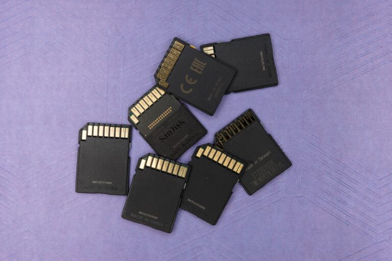 Photo of several SD cards clustered together and facing down on a patterned purple background